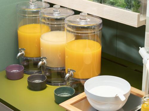 a group of four jars of orange juice on a counter at Vessel Inn Takadanobaba Station in Tokyo