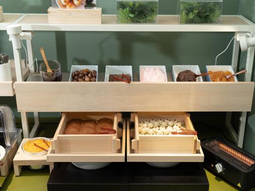 a shelf filled with lots of different types of food at Vessel Inn Takadanobaba Station in Tokyo