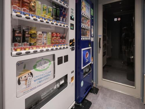 a vending machine with food and drinks in it at Vessel Inn Takadanobaba Station in Tokyo