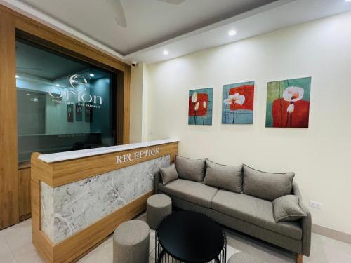 a waiting room with a couch in front of a store at Orion Hotel Halong in Ha Long