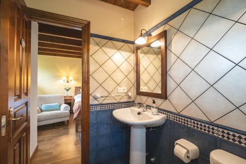 a bathroom with a sink and a mirror at La Coqueta Del Sueve in Arriondas
