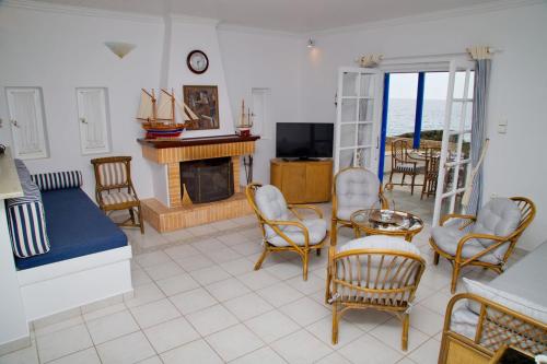 A television and/or entertainment centre at Aroura Homes 4BR Beachfront Villa