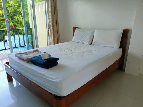 a bedroom with a bed with a laptop on it at Pranee Bungalow in Koh Tao