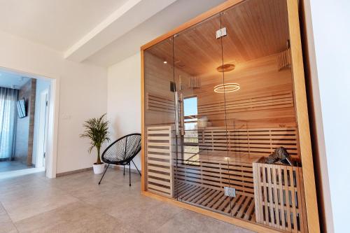 een kamer met een glazen wand met een tafel en een stoel bij Villa Andris-luxury villa near sandy beach - by TRAVELER tourist agency KRK in Ližnjan