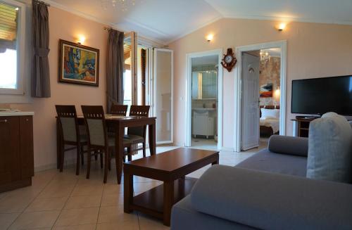 a living room with a couch and a dining room at Villa Ilias in Parga