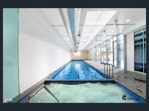 a large indoor swimming pool in a building at MelbCBD Central NYE Fireworks large 3BR2BTH GymPool in Melbourne