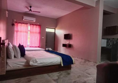 a bedroom with a large bed and a window at Hotel Golden Heights Gokarna in Gokarna