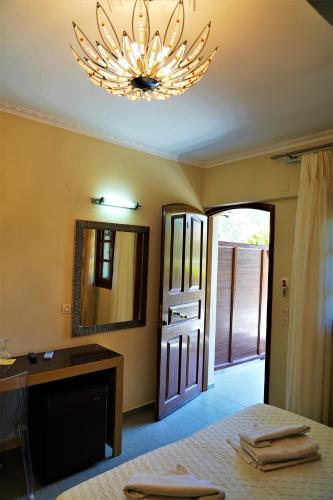 a bedroom with a bed and a mirror and a sink at Villa Ilias in Parga