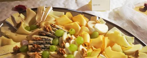 a plate of food with grapes and nuts on a table at Hotel Ludmila in Mělník