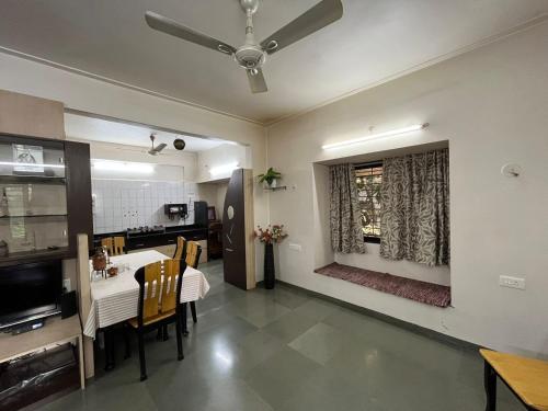 a kitchen and dining room with a table and chairs at Tripvana Apartment in Nashik