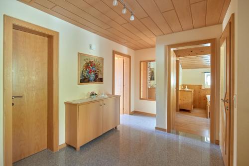 a hallway with a wooden door and a room at Schuler's Panoramablick in Silbertal