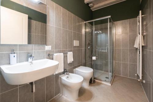 a bathroom with a sink and a toilet and a shower at Le Stanze di Gianmarmo - Via Marsala in Mirandola