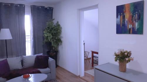 a living room with a couch and a table at Penzión Florens, Nesvady in Nesvady