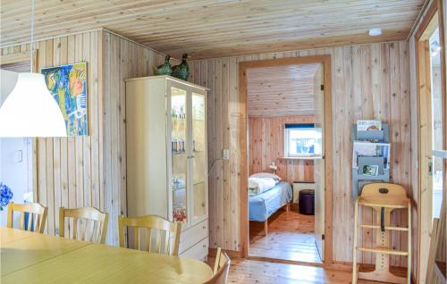 Udsholt SandにあるAmazing Home In Grsted With 5 Bedrooms, Sauna And Wifiのダイニングテーブルとベッドルームが備わります。