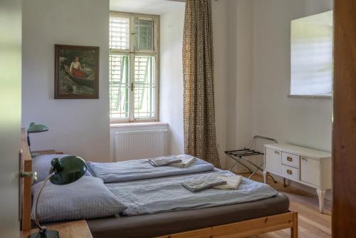 a small bedroom with a bed and a window at Schloss Hornegg in Preding