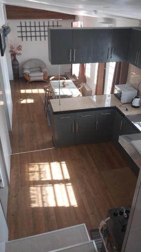 a kitchen with a counter top and a wooden floor at BIDESI VILLA Apartments in Suva
