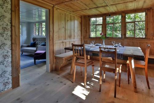 a wooden dining room with a table and chairs at Ferien im Baudenkmal Toggenburg Bergli in Ebnat