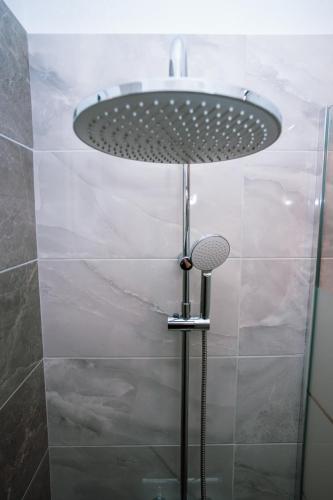 a shower with a circular sink in a bathroom at Seashell Luxury Apartment in Nikiti