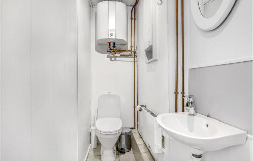 a small bathroom with a toilet and a sink at Mosvig in Sønder Bjert