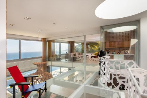 an open living room with glass floors and a glass ceiling at Casa Nami Costa Brava - BY EMERALD STAY in Sant Feliu de Guíxols
