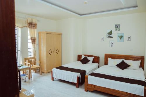 a bedroom with two beds in a room at Hoan Hao Hotel in Ha Giang