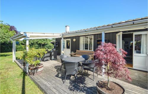 a wooden deck with a table and chairs at 3 Bedroom Stunning Home In Haderslev in Haderslev
