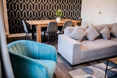 a living room with a couch and a table at Urban Escape - Stylish 3Bedroom in Watford Center in Watford