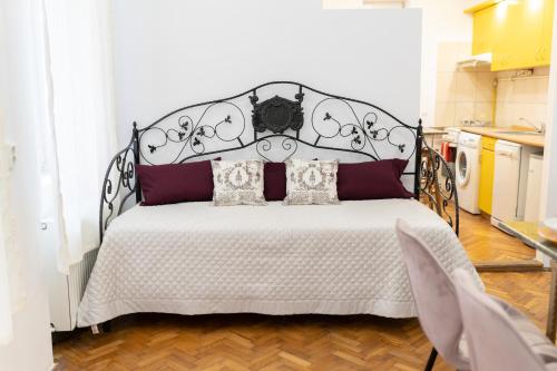 a bedroom with a black and white bed with pillows at 5* noble house in historic center in Cluj-Napoca