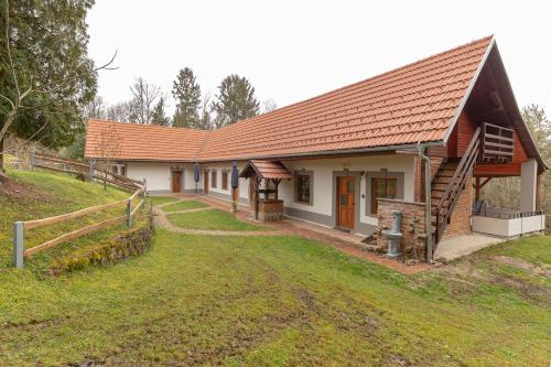 a house with a fence in front of it at Goričko Relax House in Kuzma