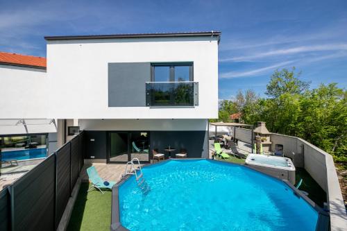 a swimming pool in the backyard of a house at Villa Veroniq in Županje