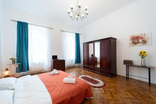a bedroom with a bed with two towels on it at 5* noble house in historic center in Cluj-Napoca