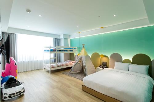 a bedroom with a bed and a tent at Interburgo Hotel Wonju in Wonju
