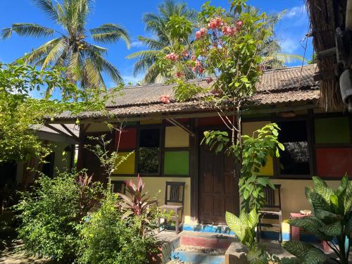 a house in the middle of a garden at Big Daddy´s Surfcamp in Pasanggaran