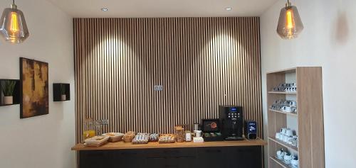 a room with a counter with a coffee maker on it at Hôtel L'Alsace in Narbonne