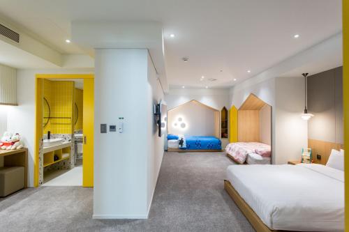 a hotel room with a bed and a bathroom at Interburgo Hotel Wonju in Wonju