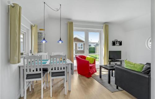 a kitchen and living room with a table and chairs at Two-Bedroom Holiday Home In Otterup in Otterup