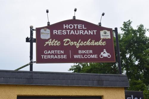 a sign on the top of a hotel restaurant at Alte Dorfschänke in Kinderbeuern