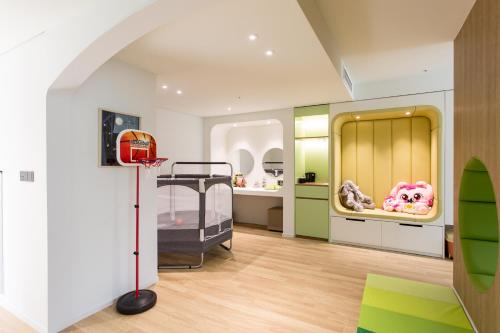 a childrens room with a basketball hoop and a bed at Interburgo Hotel Wonju in Wonju