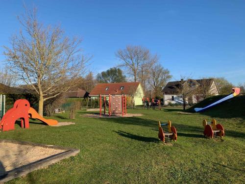 a group of toy squirrels in a park with a playground at Apartment Klausdorf 2 in Klausdorf Mecklenburg Vorpommern