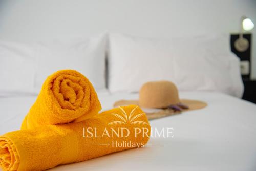 a rolled up towel with a hat on a bed at Seaviews 2x Bedroom Apartment in Sand Club Complex in San Miguel de Abona