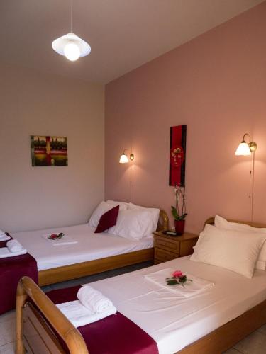 a hotel room with two beds with flowers on them at Leader in Mytikas