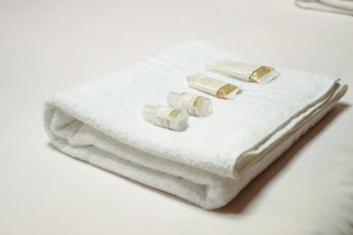 a stack of white towels with rings on them at [DUOMO] Elegant Penthouse in Parma