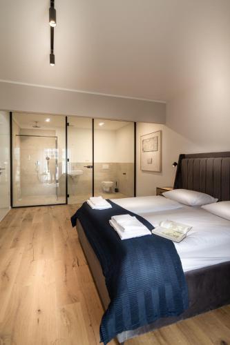 a bedroom with a large bed with glass walls at Sleep Inn Medienhafen Suites in Düsseldorf