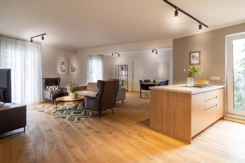 an open living room with a kitchen and a living room at Sleep Inn Medienhafen Suites in Düsseldorf