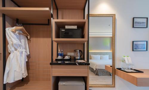 a hotel room with a bed and a mirror at Navada Beach Hotel in Nha Trang