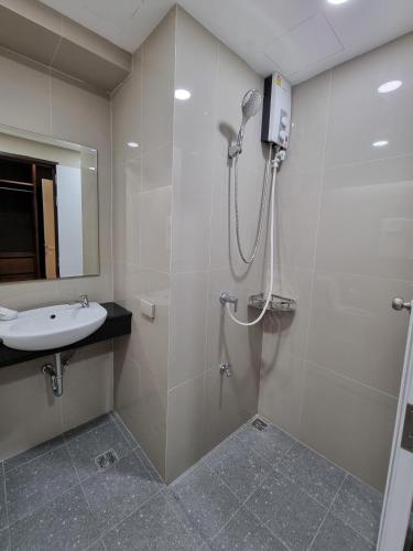 a bathroom with a shower and a sink at Tiara Place in Bangkok