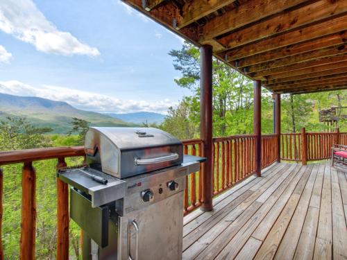 a grill on a deck with a view of the mountains at Edens View in Gatlinburg