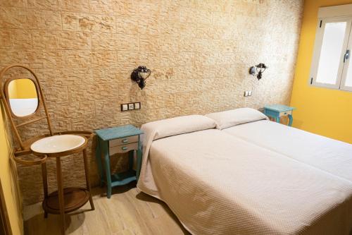 a bedroom with a bed and a sink and a mirror at Hotel Un lugar en la Vecilla in Dueñas