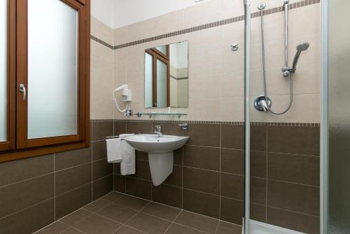 a bathroom with a sink and a shower at Isola di San Servolo - Centro Soggiorno in Venice