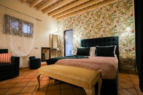 a bedroom with a bed and floral wallpaper at APRIL Luxury Suites in Rhodes Town